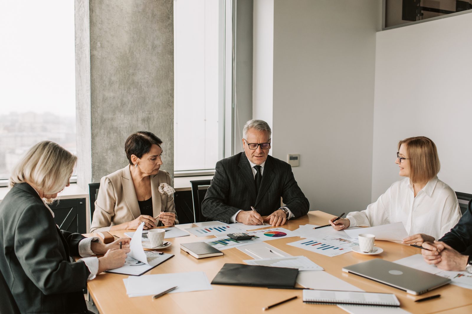 Business professionals reviewing verification documents